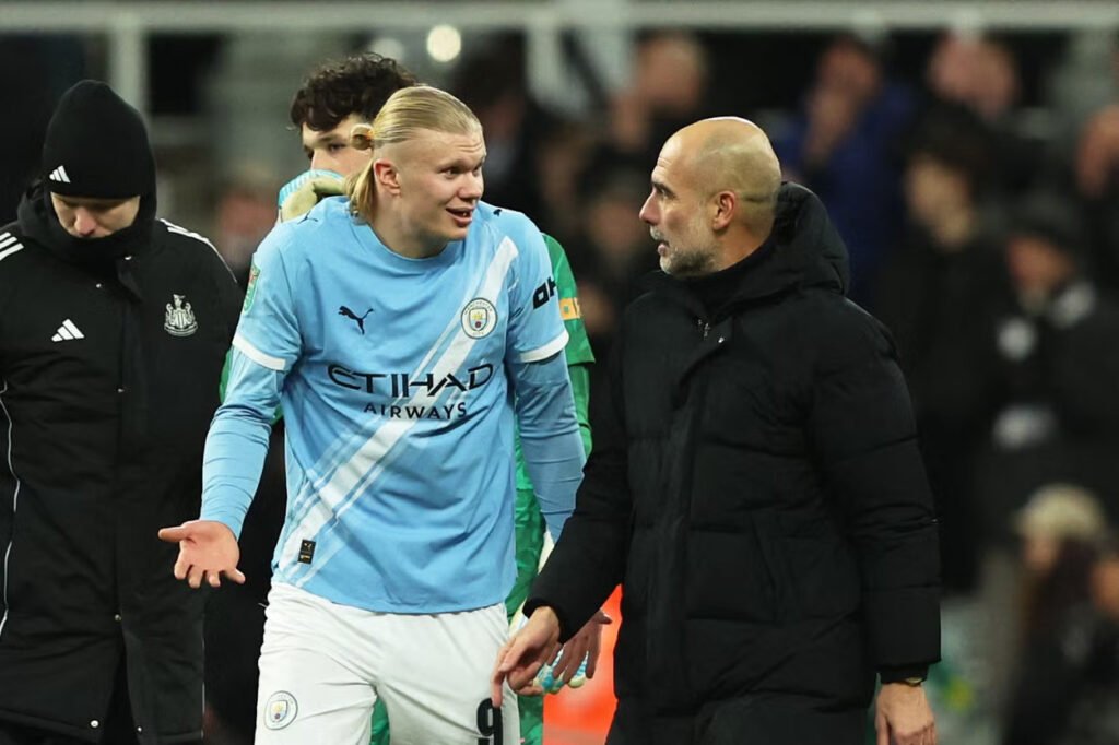 Pep Guardiola talks with Erling Haaland after the match
