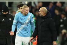 Pep Guardiola talks with Erling Haaland after the match