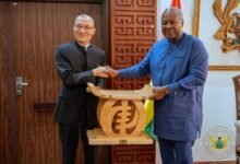 President Mahama presenting a gift to Mr Tong Defa,the outgoing Chinese Ambassador to Ghana