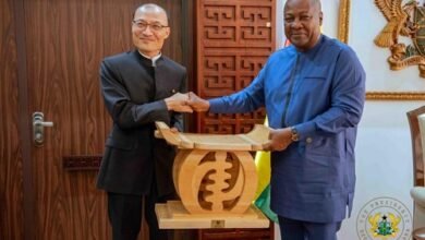 President Mahama presenting a gift to Mr Tong Defa,the outgoing Chinese Ambassador to Ghana