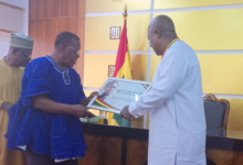 President Mahama receives ----President Mahama (right) receiving an award from Dr Paul Kofi Fynn and Dr Dee Otibu-Asare looks on