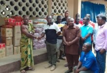 Prof Kpessah-Whyte(second left)presenting the items to Nene Someh on behalf of the victims.