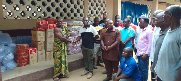 Prof Kpessah-Whyte(second left)presenting the items to Nene Someh on behalf of the victims.