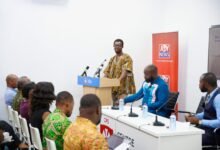 Professor Alagidede (standing) addressing the participants