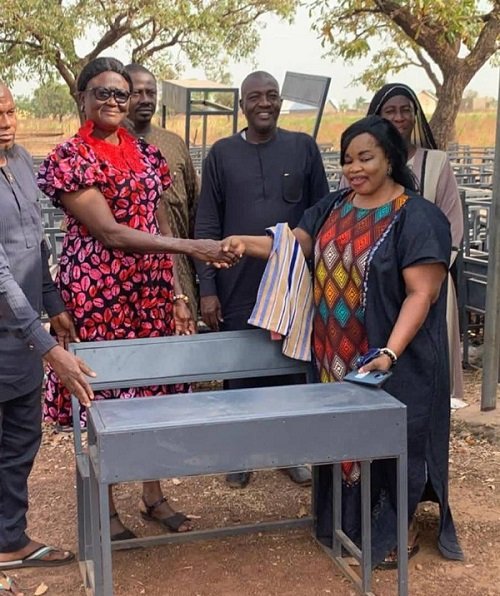 Mrs Zenabu Abdul Rahaman (right) , presenting the desk to the officials of Nanton GES