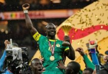 Sadio Mane, with AFCON trophy, enjoys a kingly ride from his colleagues
