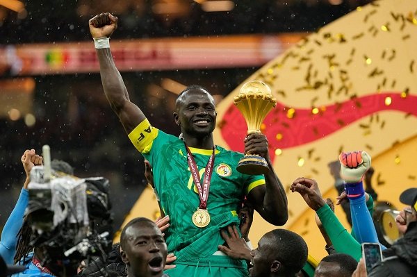 Sadio Mane, with AFCON trophy, enjoys a kingly ride from his colleagues
