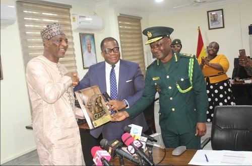 Rev. Wengam (middle) and Comptroller-General of Immigration, Mr Basintale Amadu jointly presenting an award to Alhaji Muntaka Mohammed-Mabarak (left) during the visit. Photo. Ebo Gorman