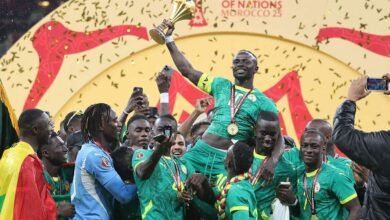 Senegal's Sadio Mane holds the trophy as they celebrate their success