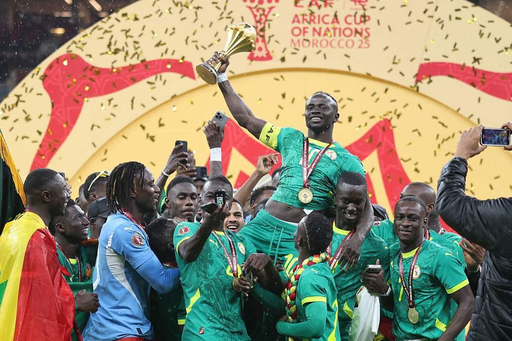 Senegal's Sadio Mane holds the trophy as they celebrate their success