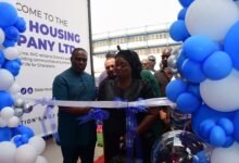 Mr Gilbert Adjei (left) assisting Mrs Sarpong to cut the tape to open the facility Photo Seth Osabukle