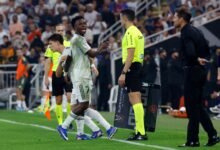 Vinicius (left) takes a swipe at Simeone after heated tussle