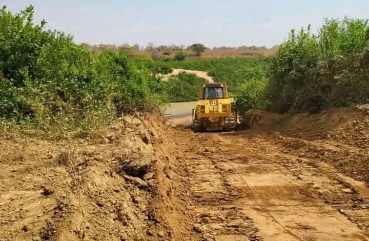 bulldozers clearing the way for construction of the bridge