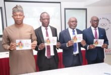 • Dr Fred Awaah (second left), GOC Secretary General, Mohammed Muniru Kassim (left), Mr Akpokavie (second right) and Mr Essilfie (right) displaying the document