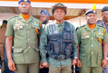 Mr Mburidiba (middle) with the two army officers