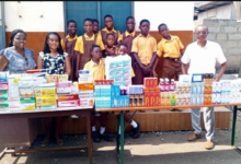 • Ataa Lartey (right) with some of the school children after the donation