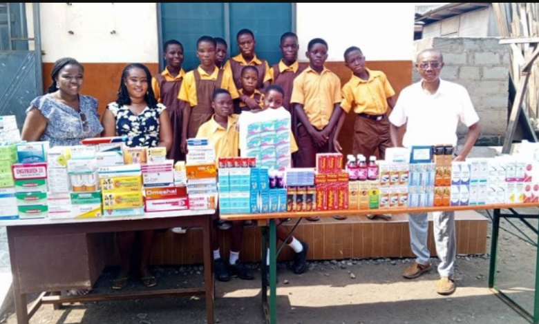 • Ataa Lartey (right) with some of the school children after the donation