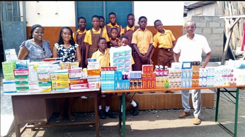 • Ataa Lartey (right) with some of the school children after the donation