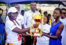 • Naana Kakie presenting the trophy to a player of Matrix