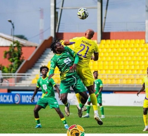 A Medeama player (in yellow) has the advantage in this aerial tussle with Aduana FC players