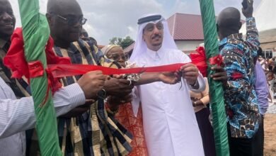Mr Abdul-Latif Dan (in smock) being assisted to cut the tape to inaugurate the facility