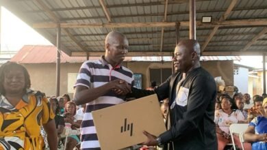• Dr Michael Mensah (right) presenting an item to a beneficiary