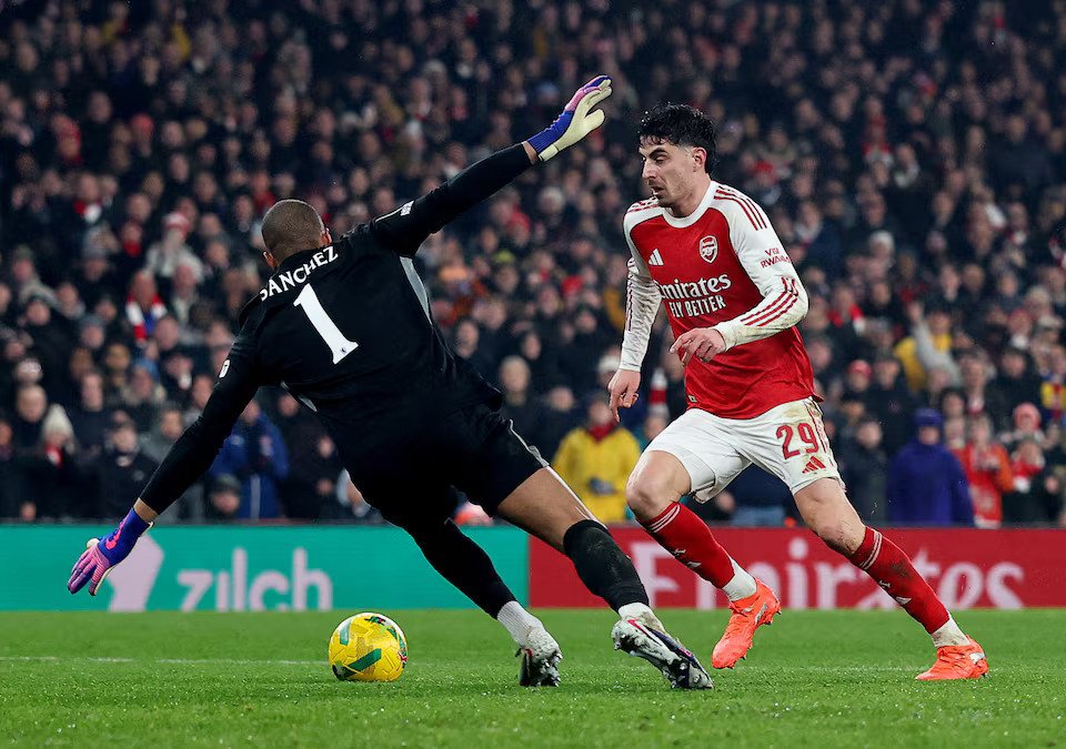 Arsenal's Kai Havertz in action with Chelsea's Robert Sanchez before he scores their first goal
