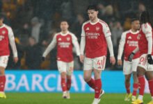 Dejected Arsenal players walking off the field after the game