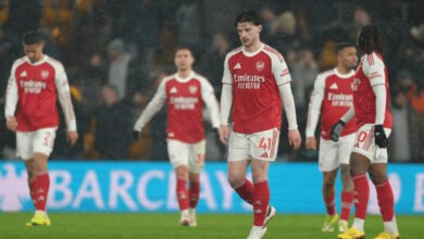 Dejected Arsenal players walking off the field after the game