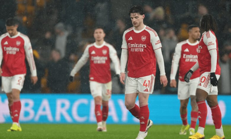 Dejected Arsenal players walking off the field after the game