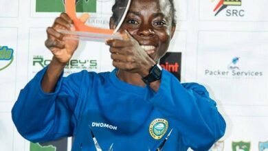 • Elizabeth Opoku display ing her top scorer award