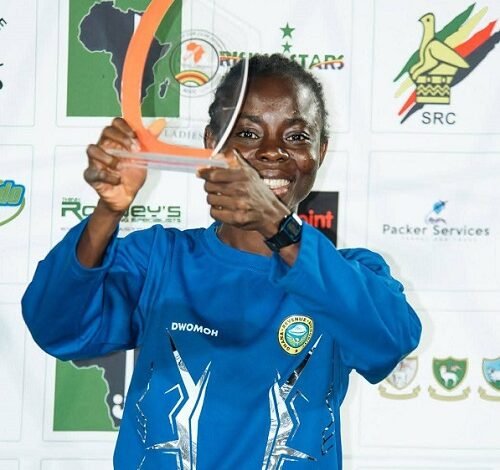 • Elizabeth Opoku display ing her top scorer award