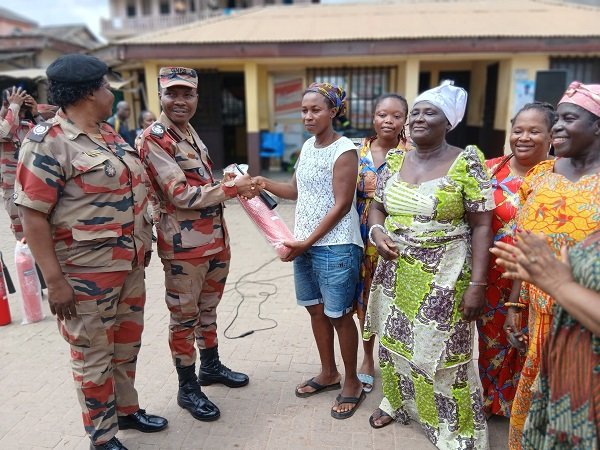 ACFO Darko( second from left) presenting a fire extinguisher to the Apremdo team