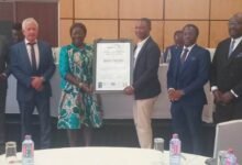 Mrs Ofosu-Adjare (left) presenting the ISO certificate to Dr Adjei