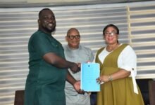 Mr Ludwig Teye Totimeh (left) and Ms Ocloo after signing the performance document Photo Seth Osabukle