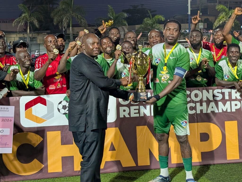 Greater Accra RFA chairman Samuel Aboabire presenting the winners trophy to skipper of La Salem Jonathan Quartey