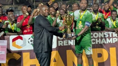 Greater Accra RFA chairman Samuel Aboabire presenting the winners trophy to skipper of La Salem Jonathan Quartey