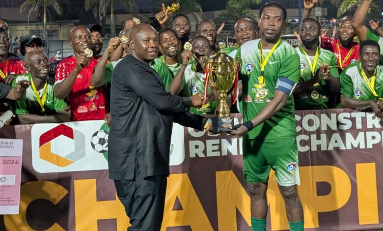 Greater Accra RFA chairman Samuel Aboabire presenting the winners trophy to skipper of La Salem Jonathan Quartey
