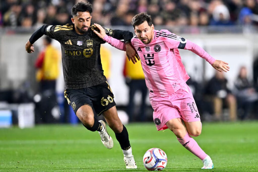 Messi (10) moves the ball against Los Angeles FC’s Mathieu Choinière (66) during the second half at Los Angeles Memorial Coliseum