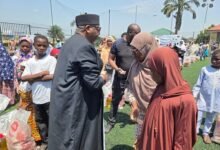 Sheikh Ibrahim(left) presenting the food package to the needy
