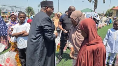 Sheikh Ibrahim(left) presenting the food package to the needy