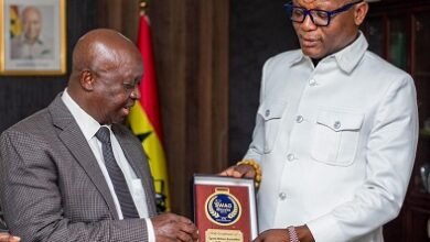 Mr Kwabena Yeboah (left) presents a SWAG branded souvenir to Mr Adams