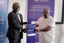 • Mr Squire (left) exchanging the MoU document with Mr Quaye