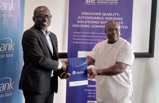 • Mr Squire (left) exchanging the MoU document with Mr Quaye