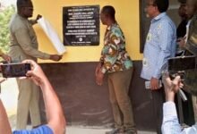 Mr Awal Joseph Antwi (left) and Mr Geoffrey Kini unveiling a plaque to inaugurate the new classroom block