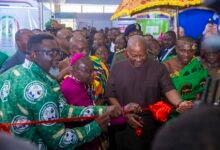 • President Mahama (middle) being assisted to cut the tape at the event