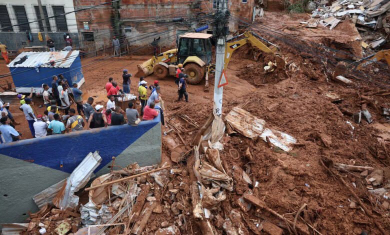 Rescue workers search for victims among debris