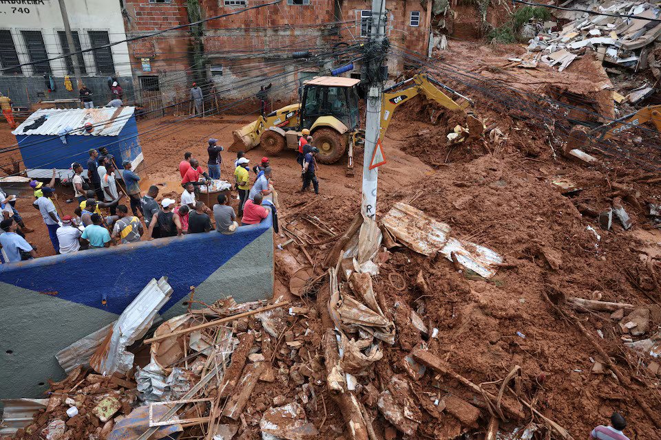 Rescue workers search for victims among debris