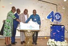 Mr Nikpe (second from right) being assisted by Rev Arthur (right) to cut the anniversary cake after unveiling the logo. With them is Mr Allotey (second from left) Photo Victor A. Buxton
