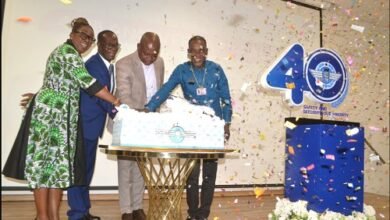 Mr Nikpe (second from right) being assisted by Rev Arthur (right) to cut the anniversary cake after unveiling the logo. With them is Mr Allotey (second from left) Photo Victor A. Buxton